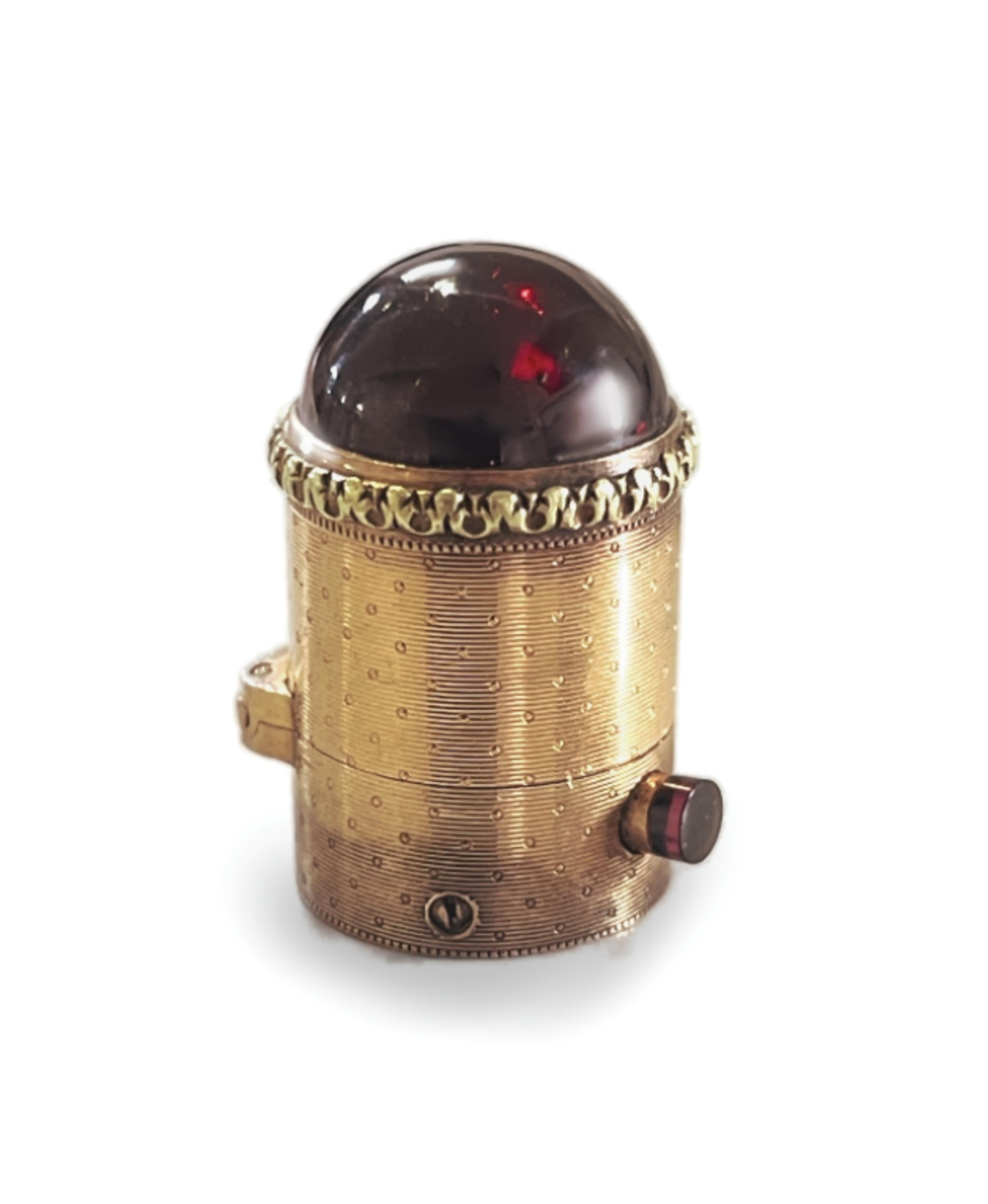 A gold and garnet perfume bottle top, France, late 19th century